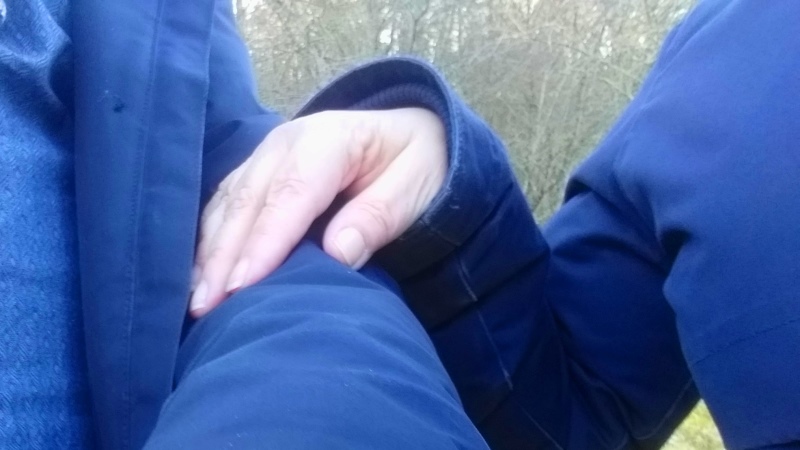 En hand som håller på en arm.